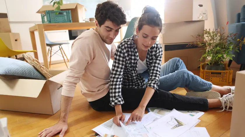 A happy young couple moving into a new apartment