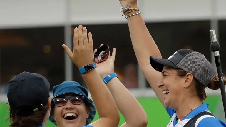 From left, Italy's Lucilla Boari, Guendalina Sartori, and Claudia Mandia, celebrate during the women's team archery competition at the Sambadrome venue during the 2016 Summer Olympics in Rio de Janeiro, Brazil, Sunday, Aug. 7, 2016. (AP Photo/Alessandra Tarantino)