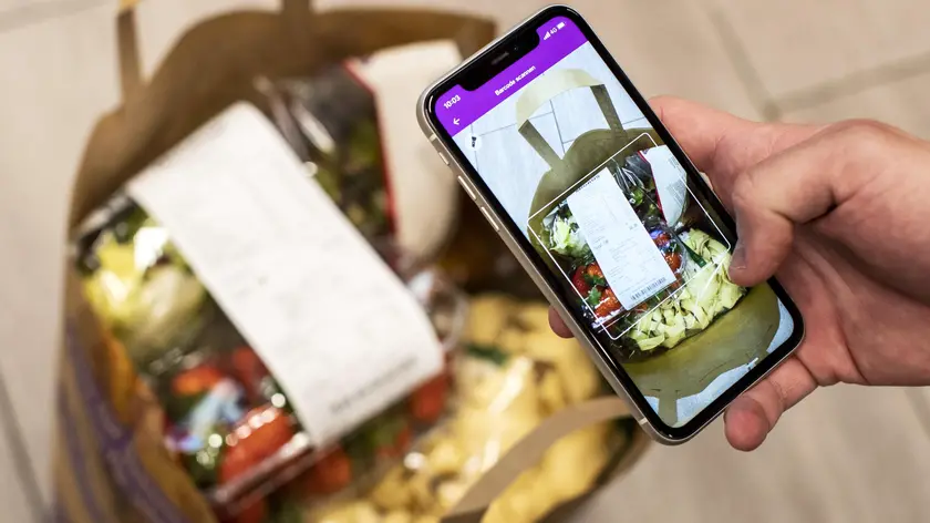 epa08368847 Volunteer Niccolo Brunetti does shopping via the 'Amigos-App' in the supermarket Migros at the Limmatplatz in Zurich Switzerland, 17 April 2020. With the app, Migros and Pro Senectute offer a possibility for neighbourhood help during the coronavirus pandemic. EPA/ALEXANDRA WEY