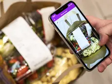 epa08368847 Volunteer Niccolo Brunetti does shopping via the 'Amigos-App' in the supermarket Migros at the Limmatplatz in Zurich Switzerland, 17 April 2020. With the app, Migros and Pro Senectute offer a possibility for neighbourhood help during the coronavirus pandemic. EPA/ALEXANDRA WEY