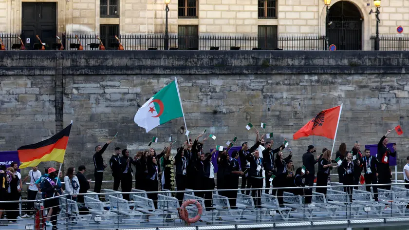 epa11497552 Atheltes from Albania (R), Algeria (C), and Germany (L) wave their flags during the Opening Ceremony of the Paris 2024 Olympic Games, in Paris, France, 26 July 2024. EPA/MOHAMMED BADRA