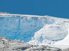 A rescue helicopter flies over the Punta Rocca glacier near Canazei, in the Italian Alps in northern Italy, Wednesday, July 6, 2022, where an avalanche broke loose on Sunday, sending tons of ice, snow, and rocks onto hikers. (AP Photo/Luca Bruno)