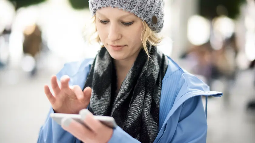 woman using smartphone, in Munich, Germany.