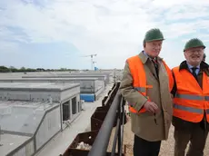 L'ing. Giovanni Mazzacurati ( a sx della foto con occhiali scuri), direttore dei lavori del Consorzio Venezia Nuova, e il sindaco di Venezia Giorgio Orsoni ( a dx della foto) posano dall'alto della conca con i cassoni di alloggiamento in cemento delle paratie mobili, sulla bocca di porto di Cavallino-Treporti, il 28 aprile 2011. ANSA/ANDREA MEROLA