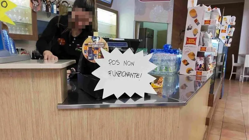 Il cartello con scritto “Pos non funzionante” nel locale