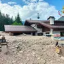 Una casa invasa da sassi e ghiaia della frana a Cancia (foto vigili del fuoco)
