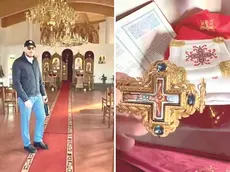 Padre Alexandru Anitei all’interno della chiesa, a destra una delle croci a cui è stata strappata la catenina