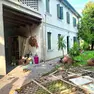Il portone del garage scaraventato in giardino dopo l'esplosione