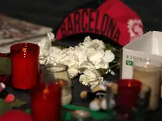 Candles and bunches of flowers placed by people rest on the ground in Las Ramblas, Barcelona, Spain, Friday, Aug. 18, 2017. Police on Friday shot and killed five people carrying bomb belts who were connected to the Barcelona van attack, as the manhunt intensified for the perpetrators of Europe's latest rampage claimed by the Islamic State group. (ANSA/AP Photo/Francisco Seco) [CopyrightNotice: Copyright 2017 The Associated Press. All rights reserved.]