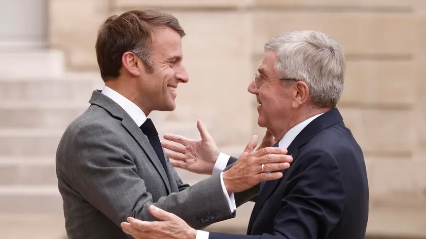epa11481712 French President Emmanuel Macron (L) greets International Olympic Committee (IOC) President Thomas Bach (R) upon his arrival at the Elysee Palace in Paris, France, 16 July 2024. The 2024 Summer Olympics are held in Paris from 26 July to 11 August 2024 and the Paralympic from 28 August to 08 September 2024. EPA/YOAN VALAT