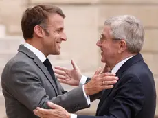 epa11481712 French President Emmanuel Macron (L) greets International Olympic Committee (IOC) President Thomas Bach (R) upon his arrival at the Elysee Palace in Paris, France, 16 July 2024. The 2024 Summer Olympics are held in Paris from 26 July to 11 August 2024 and the Paralympic from 28 August to 08 September 2024. EPA/YOAN VALAT