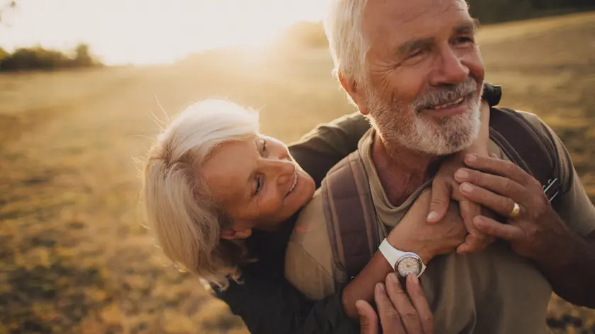 Photo of an elderly couple, who still enjoy in each other, is on a hiking trip together
