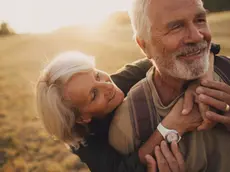 Photo of an elderly couple, who still enjoy in each other, is on a hiking trip together