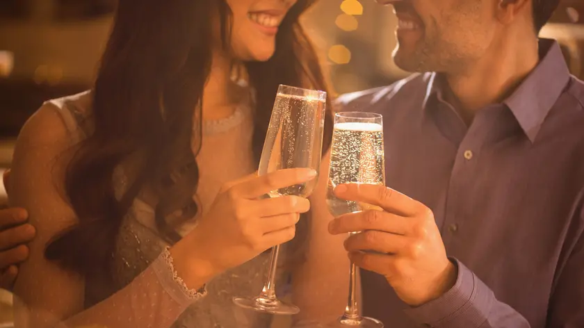 Affectionate couple toasting champagne flutes
