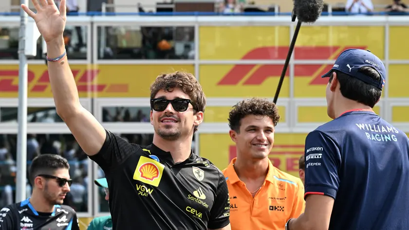 Scuderia Ferrari driver Charles Leclerc of Monaco (L) waves the crowd during the drivers parade of the Formula One Grand Prix of Italy, Monza, Italy, 01 September 2024. ANSA/DANIEL DAL ZENNARO