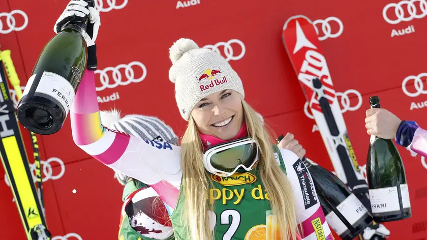 Lindsey Vonn of the USA celebrates on the podium after winning the women's FIS Alpine Skiing World Cup SuperG race in Cortina d'Ampezzo, Italy, 19 January 2015. ANSA/ANDREA SOLERO