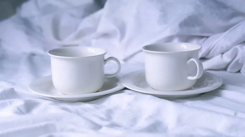 Cups of coffee in bed