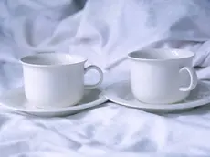 Cups of coffee in bed