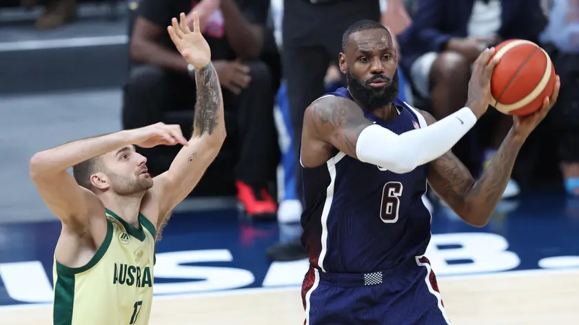 epa11480327 LeBron James (R) of the USA and Jack McVeigh of Australia in action during the 2024 USA Basketball Showcase game between USA and Australia in Abu Dhabi, United Arab Emirates, 15 July 2024. EPA/ALI HAIDER
