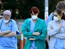 People and health workers wear protective face masks outside the hospital in Padua, Veneto region, northern Italy, 22 February 2020. A second person in Italy has died after being infected with the coronavirus. The death of a woman in the northern region of Lombardy follows that of a 78-year-old man who died on Friday. The new wave of cases in Italy's northern regions have triggered shut-downs of shops, offices and community centres. ANSA/NICOLA FOSSELLA