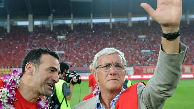 epa03449522 Guangzhou Evergrande coach Marcello Lippi gestures to fans after winning the championship of China's top soccer league in Guangzhou in south China's Guangdong province 27 October 2012. It is Lippi's first year in China and Evergrande's second league title. EPA/WILSON WEN CHINA OUT