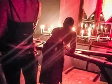 Lozzo Atestino (PD), 8 ottobre 2017. Festa "Decadence" al castello di Valbona. Nella foto: una dominatrice frusta un ragazzo in una saletta del piano superiore.