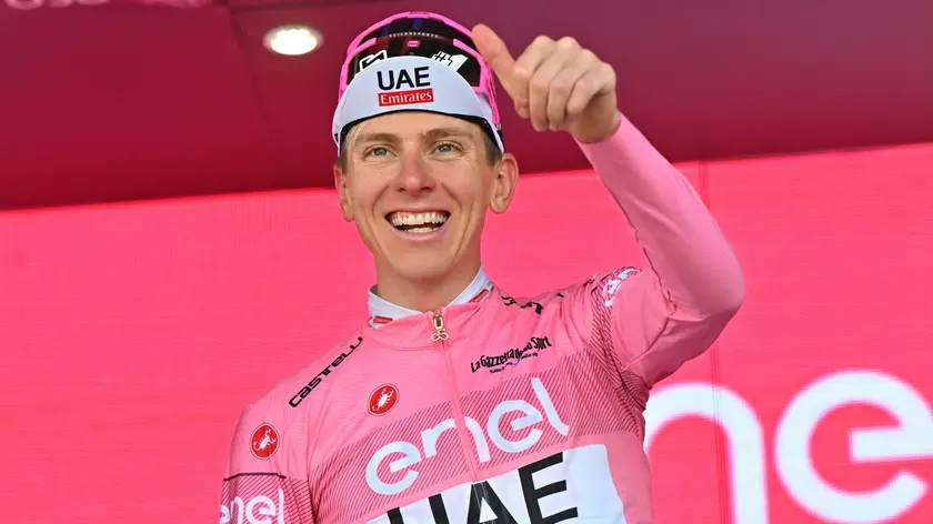 Slovenian rider Tadej Pogacar of Uae Team Emirates retaining the overall leader's pink jersey celebrates on the podium after the 20th stage of the 107 Giro d'Italia 2024, cycling race over 184 km from Alpago to Bassano del Grappa, Italy, 25 May 2024. ANSA/LUCA ZENNARO