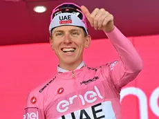 Slovenian rider Tadej Pogacar of Uae Team Emirates retaining the overall leader's pink jersey celebrates on the podium after the 20th stage of the 107 Giro d'Italia 2024, cycling race over 184 km from Alpago to Bassano del Grappa, Italy, 25 May 2024. ANSA/LUCA ZENNARO