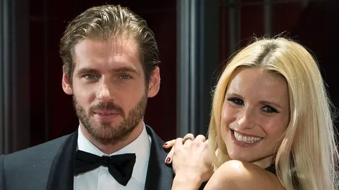 03 Nov 2012, Bern, Switzerland --- epa03456951 Swiss TV personality Michelle Hunziker (R) and her companion, Italian Tomaso Trussardi (L), pose for the media as they arrive on the red carpet prior to a gala night in Bern, Switzerland, 03 November 2012. The 'Gala de Berne' is a new event that should bring more stars and glamour to Switzerland’s capital. EPA/PETER SCHNEIDER --- Image by © PETER SCHNEIDER/epa/Corbis