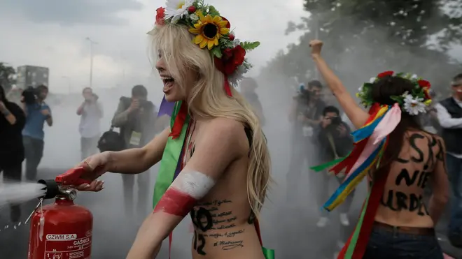 Women of Ukraine's controversial women's rights movement Femen stage a topless protest in front of the Warsaw stadium ahead of the Euro 2012 soccer championship Group A match between Poland and Greece in Warsaw, Poland, Friday, June 8, 2012. (AP Photo/Gero Breloer)