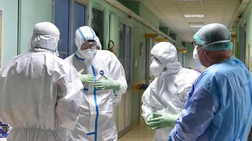 Healthcare professionals wearing protective suits and healthcare masks at work inside the isolation area of the Amedeo di Savoia hospital in Turin, northern Italy, 05 March 2020. Premier Giuseppe Conte said Thursday the cabinet had earmarked 7.5 billion euros "to support families and businesses that are facing the (coronavirus) emergency". "They are extraordinary and urgent measures", he said. "On the deficit there has not been any leap into the dark", he said, and stressed "the EU will understand"..ANSA/ ALESSANDRO DI MARCO