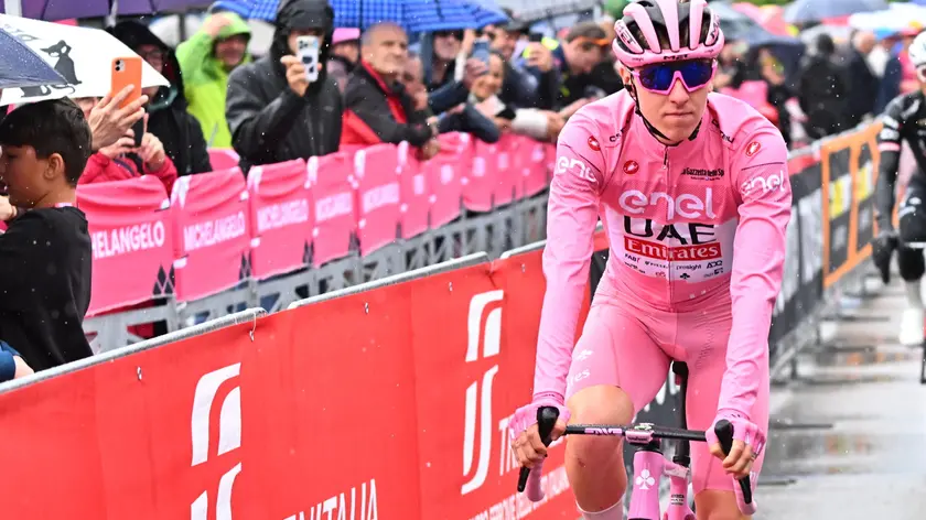 Slovenian rider Tadej Pogacar of team Uae Emirates wearing the overall leader's pink jersey, on the signing in podium ahead the departure of the 20th stage of the 107 Giro d'Italia 2024, cycling race over 184 km from Alpago to Bassano del Grappa, Italy, 25 May 2024. ANSA/LUCA ZENNARO