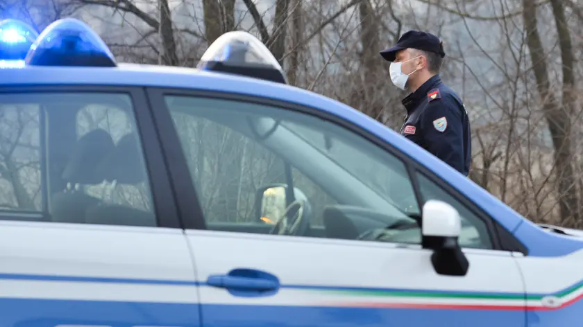 Italian National Police officers stand by as they inform residents at the entrance of the small town of Casalpusterlengo, southeast of Milan, on February 23, 2020, under the shadow of a new coronavirus outbreak, as Italy took drastic containment steps as worldwide fears over the epidemic spiralled.. ANSA/ANDREA FASANI