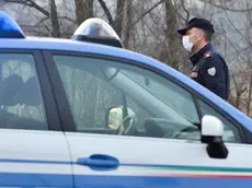 Italian National Police officers stand by as they inform residents at the entrance of the small town of Casalpusterlengo, southeast of Milan, on February 23, 2020, under the shadow of a new coronavirus outbreak, as Italy took drastic containment steps as worldwide fears over the epidemic spiralled.. ANSA/ANDREA FASANI