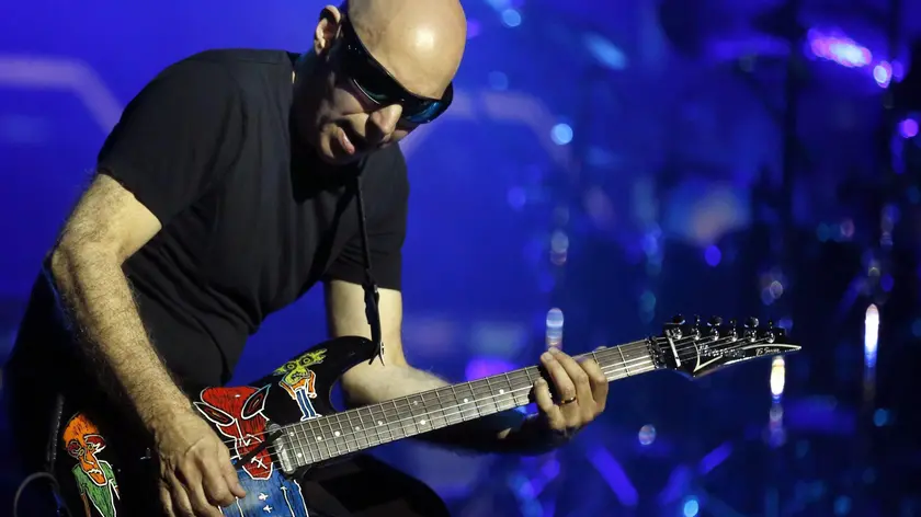 epa05414221 US instrumental rock guitarist Joe Satriani performs on stage during his concert at the Teatro de la Laboral in Gijon, Asturias, northern Spain, 07 July 2016. EPA/J.L. CEREIJIDO