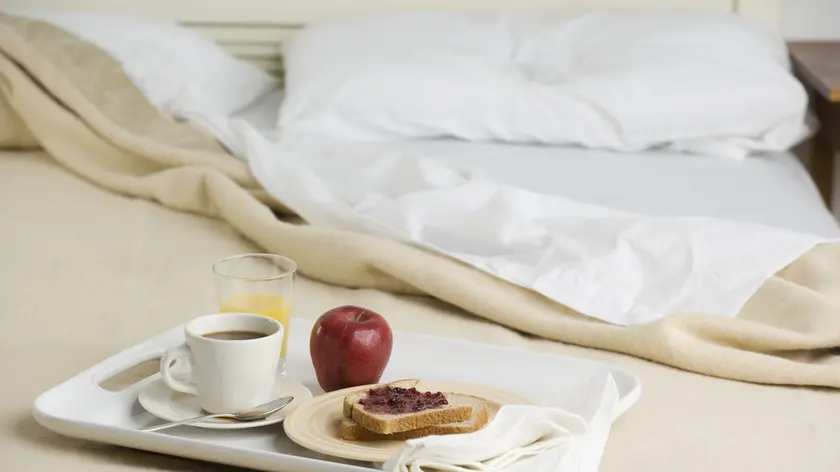 Still life of breakfast tray on bed