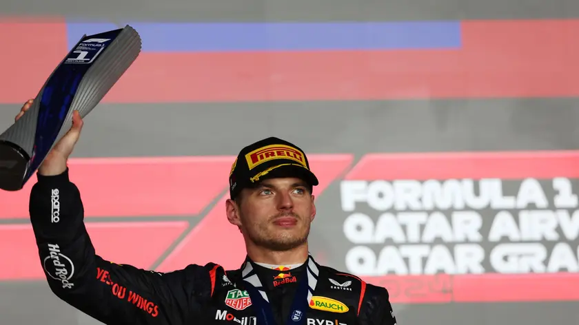 epa11752171 Red Bull Racing driver Max Verstappen of Netherlands celebrates with trophy on the podium after winning the Formula 1 Qatar Grand Prix at the Lusail International Circuit racetrack in Lusail, Qatar, 01 December 2024. EPA/ALI HAIDER