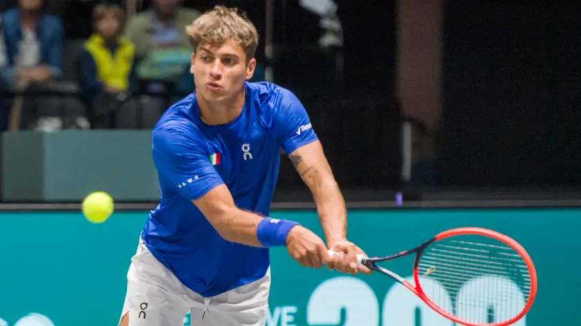 epa11602589 Flavio Cobolli of Italy in action against Zizou Bergs of Beglium during the Davis Cup tennis match between Italy and Belgium, in Bologna, Italy, 13 September 2024. EPA/MICHELE LAPINI