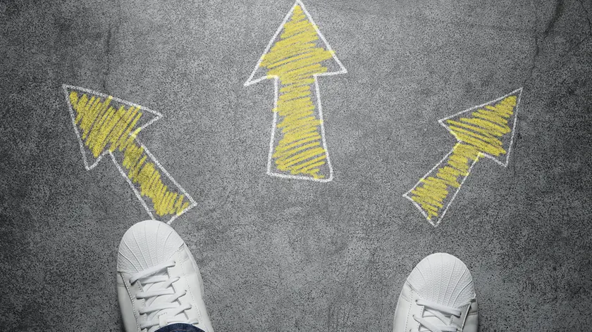 High angle view of three arrows drawn on the street, pointed in different directions