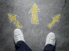 High angle view of three arrows drawn on the street, pointed in different directions