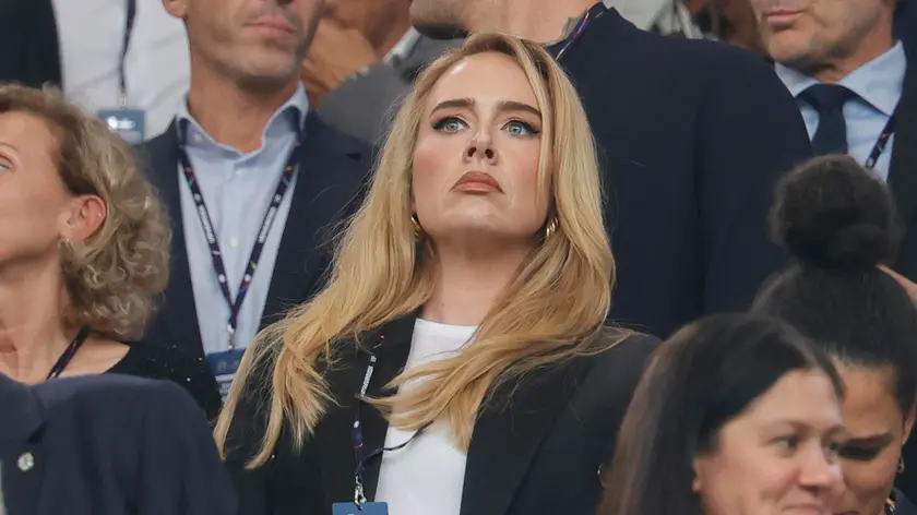 epa11470943 English singer-songwriter Adele sits in the stands ahead of the UEFA EURO 2024 semi-finals soccer match between Netherlands and England, in Dortmund, Germany, 10 July 2024. EPA/RONALD WITTEK