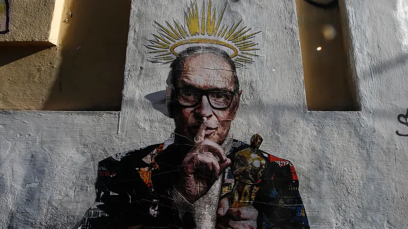 A graffiti mural, created by the artist Harrygrebdesign, depicting the Italian composer and conductor Ennio Morricone in the Trastevere district of Rome, Italy, 06 July 2020. The Oscar winner died in the night in a Roman clinic, for the consequences of a fall. The musician and composer, author of famous soundtracks of Italian and world cinema, was 93 years old. A few days ago he suffered a broken femur. ANSA/FABIO FRUSTACI