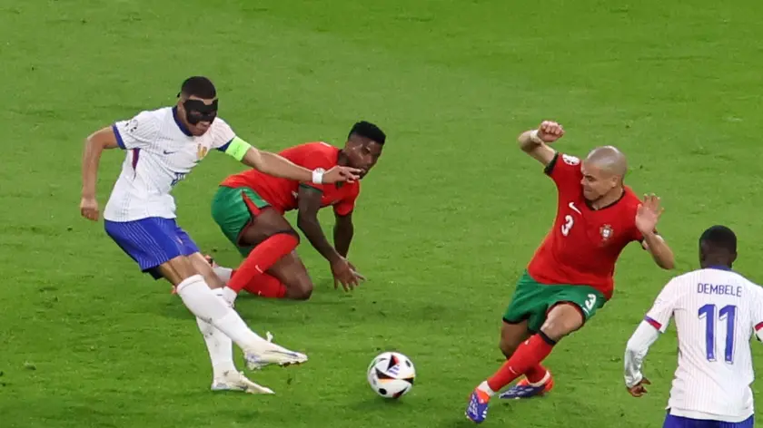 epa11460984 Kylian Mbappe of France (L) in action against Pepe of Portugal during the UEFA EURO 2024 quarter-finals soccer match between France and Portugal, in Hamburg, Germany, 05 July 2024. EPA/ABEDIN TAHERKENAREH