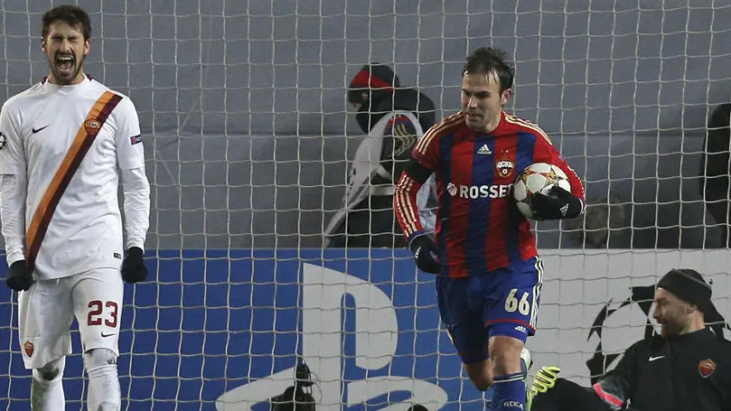 CSKA's Bebras Natcho, runs with the ball after his team scored an equalizer as Roma's Davide Astori, left, reacts and teammate goalkeeper Morgan De Sanctis sits on the ground during the Group E Champions League soccer match between CSKA Moscow and A.S. Roma at Arena Khimki stadium in Moscow, Russia, Tuesday, Nov. 25, 2014. (AP Photo/Alexander Zemlianichenko)
