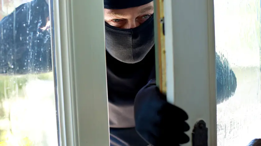 Burglar peeking at front door