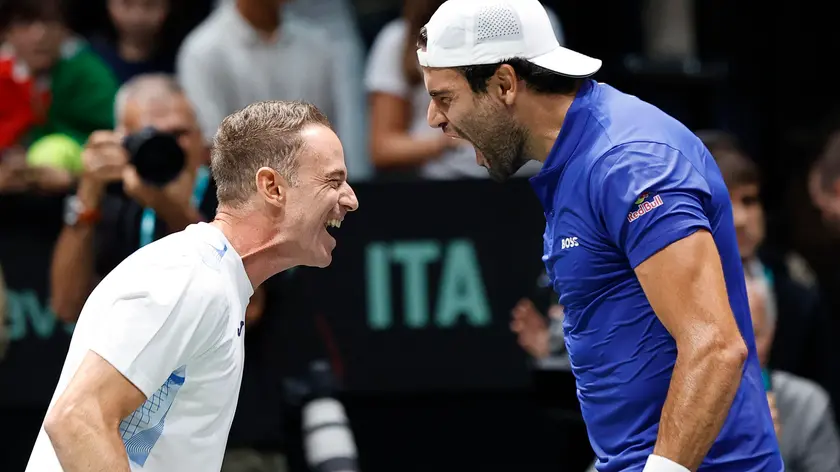 Italian tennis player Matteo Berrettini with captain team Filippo Volandri celebrates the victory against Brasilian player Joao Fonseca during the match of Davis Cup Final Group Stage at Unipol Arena in Casalecchio (Bologna) Italy, 11 September 2024. ANSA /ELISABETTA BARACCHI