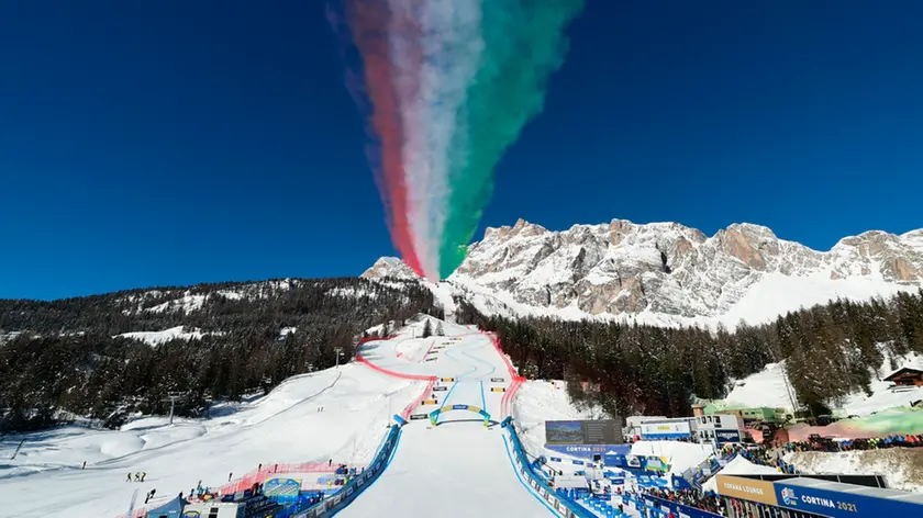 Jets of the "Frecce Tricolori" (Tri-Color Arrows) aerobatics team of the Italian Air Force fly over the men's downhill course, at the alpine ski World Championships in Cortina D'ampezzo, Italy, Sunday, Feb.14, 2021. (AP Photo/Marco Tacca)