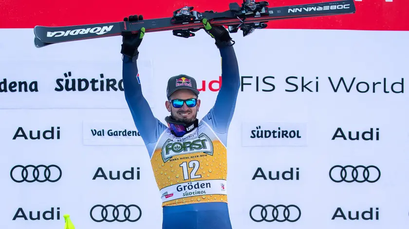 Winner Dominik Paris of Italy celebrates on the podium for the Men's Downhill race at the FIS Alpine Skiing World Cup in Val Gardena, Italy, 16 December 2023. ANSA/LUCIANO SOLERO