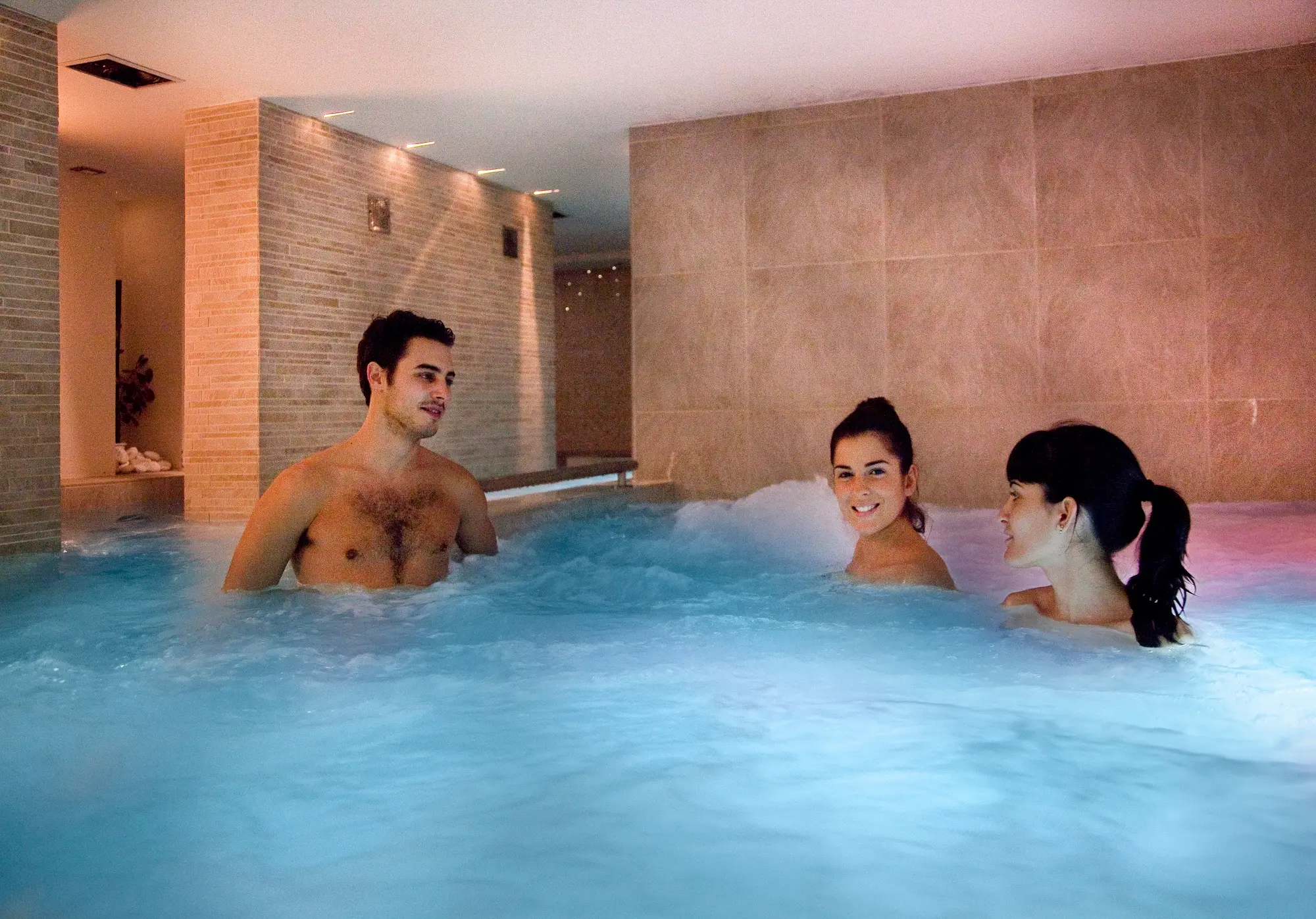 Man and women relaxing in a thermal pool