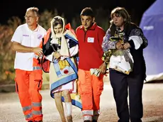 24/08/2016 Pescara del Tronto. Il paese completamente distrutto dal sisma di magnitudo 6.0 di questa notte che ha colpito il centro Italia. Le case ridotte a un cumulo di macerie, i sopravvissuti trovano conforto e riparo nella tendopoli allestita dalla protezione civile